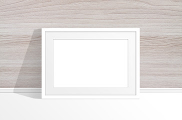 Blank photo frame near wooden panels wall
