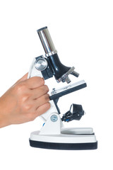 Female hand holding white science microscope isolated on white background