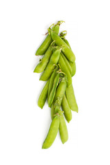 Young green stiletto peas on a white background..