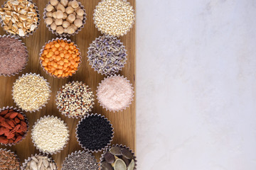 Various superfoods, seeds, cereals, grains on a  white background. Healthy eating concept. Flat...