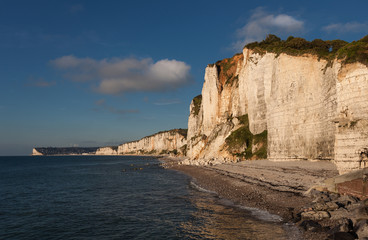 Fototapeta na wymiar The beautiful and dramatic chalk cliff coastline of Yport with Fécamp in the distance, a commune in the Seine-Maritime department in the Normandy region of north western France