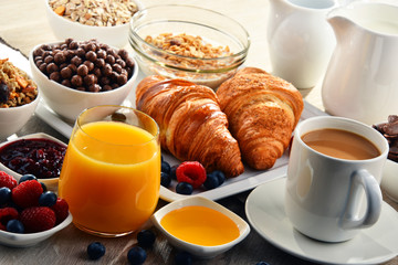 Breakfast served with coffee, juice, croissants and fruits