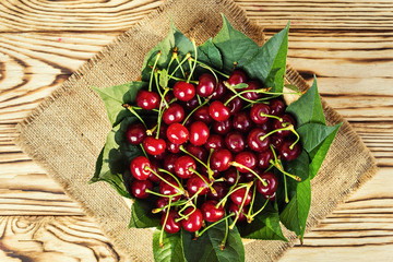 Cherries in basket on wooden table.Cherry. Cherries in bowl. Red cherry. Fresh sweet cherries with water drops,Close up.healthy food concept,soft focus