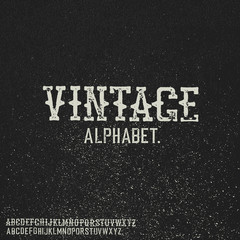 Vintage stamp alphabet. On black grunge background.