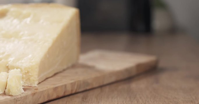 slide pieces of hard parmesan cheese on olive board