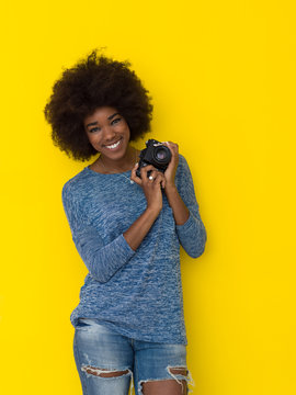 young african american girl taking photo on a retro camera