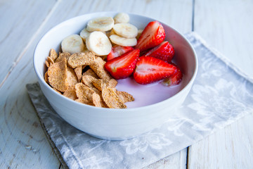 Healthy Breakfast which included cornflakes and oatflakes, yogurt, bananas and strawberries