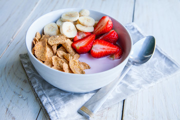 Healthy Breakfast which included cornflakes and oatflakes, yogurt, bananas and strawberries