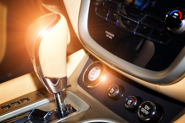 Detail of modern car interior, gear stick. Button start stop in the background of the shift lever.
