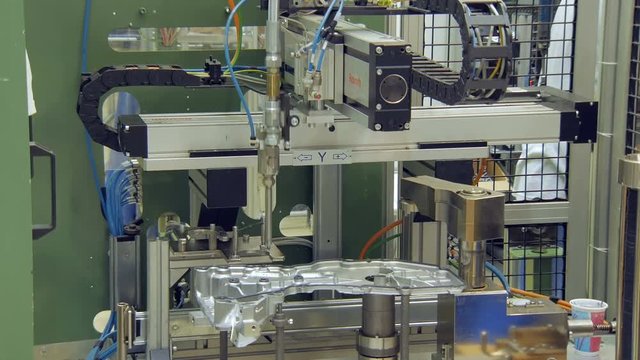 robotic process of sealing automobile details in car factory