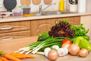 fresh fruits and vegetables on the table in kitchen interior, healthy food concept