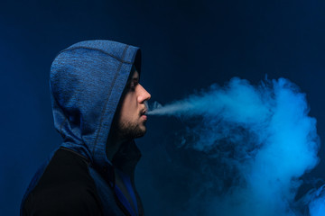 Vaping man and a cloud of vapor