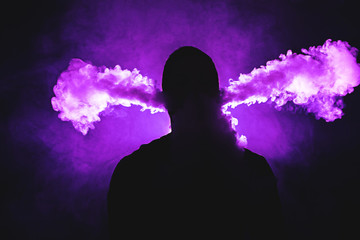 Vaping man and a cloud of vapor