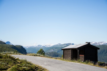 Fototapeta na wymiar Mountain hut next to road in Jotunheimen national park, Norway