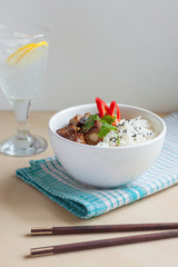 Vertical soft focus garlic pepper pork ribs with rice Asian style and fizzy drink