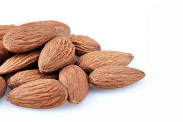 peeled almond seed on white background