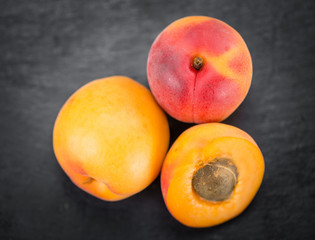 Fototapeta na wymiar Apricots on a slate slab (selective focus)