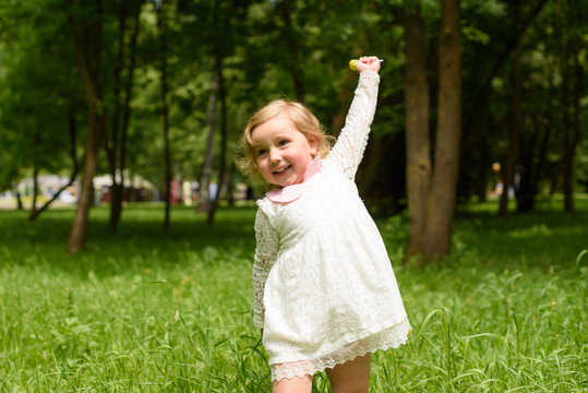 The little girl is engaged in firness in the garden