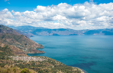 Fototapeta na wymiar Viewpoint at lake Atitlan - view to the small villages San Marcos, Panajachel and San Marcos at the lake in the highlands of Guatemala