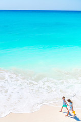 Obraz premium Adorable little girls on the beach. Top view of kids walking on the seashore