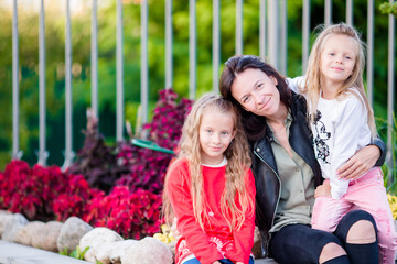 Happy family in park outdoors. Portrait of mom and kids