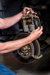 Master machanic works on a break system for a truck