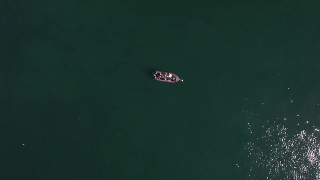 Aerial view of a small fishing boat, anchored up in Cooke Inlet Alaska, on a sunny summer day.