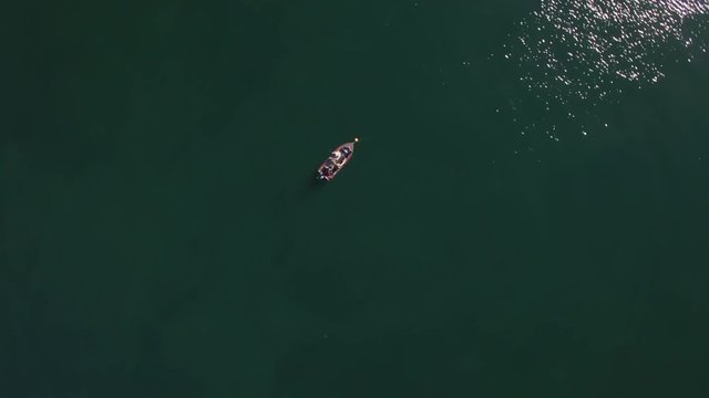 Birds eye view of a small fishing boat out at sea in Alaska, Aerial view.