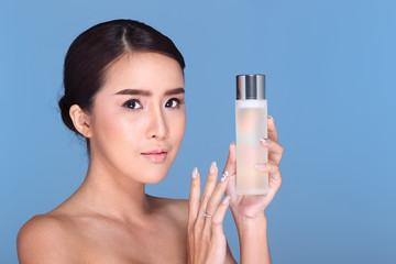 Young smiling female holding a white blank round jar bottle of Cosmetic skin care package product