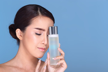 Young smiling female holding a white blank round jar bottle of Cosmetic skin care package product