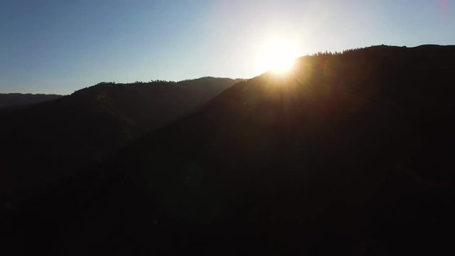 Aerial view of a sunrise over a California mountain early in the morning.
