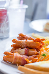 Sausages wrapped with bacon