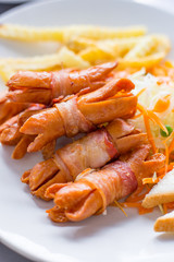 Sausages wrapped with bacon