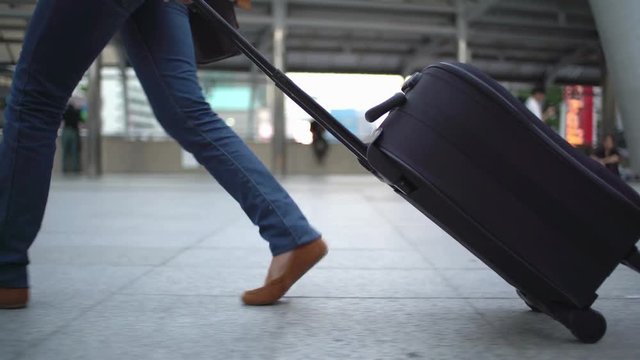 traveler dragged baggage walking on the way at downtown of Bangkok. Only legs :Gimbal shot.