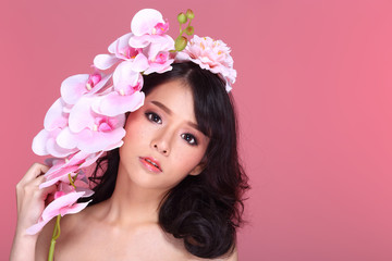 Beautiful Asian Woman black hair with flora crowd, holding bouquet artificial rose over chest