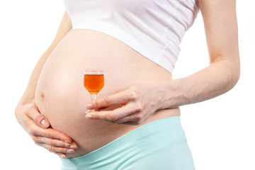 Woman in pregnant with glass of wine, concept of unhealthy lifestyles during pregnancy