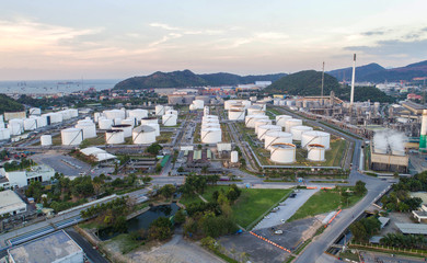 Aerial view Oil refinery with a background of mountains and sky.The factory is located in the middle of nature and no emissions. The area around the air pure.