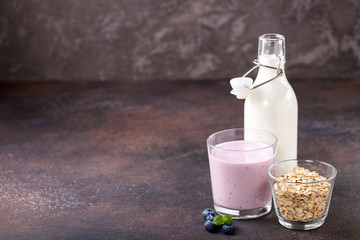 Milk, yogurt and oatmeal against a dark background. Selective focus. Copy space