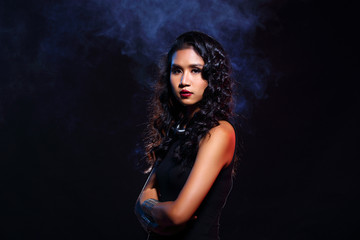 Fototapeta premium low key portrait of tan skin asian slim healthy woman in black background