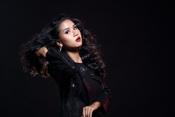 low key portrait of tan skin asian slim healthy woman in black background