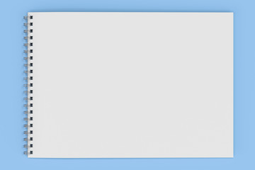 Blank white notebook with metal spiral bound on blue background