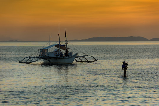  Traditional dive boats view at sunset, Donsol shore, Sorsogon province, Philippines 