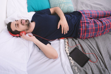 Man listening music with tablet.