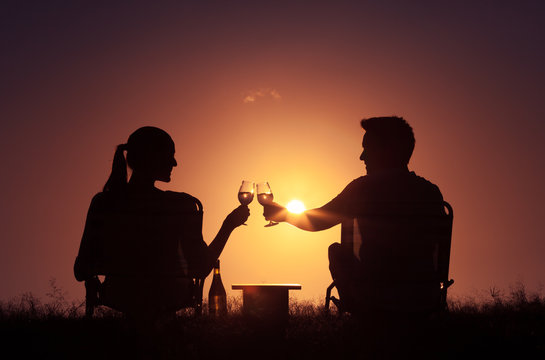Young couple outdoors enjoying a glass of wine.  Love and relationships.