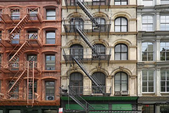 New York apartment building facades with external fire escape ladders