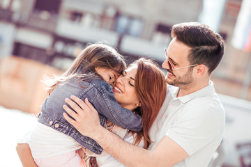 Beautiful happy family having fun in the city.