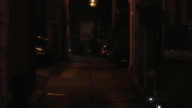 Establishing shot of a dark alleyway at night