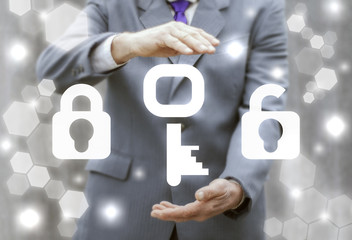 Key Lock Security Business Web Network Computing Real Estate concept. Man offers key locks icons on virtual screen.