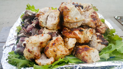 Cooking juicy and delicious pork, beef and chicken in the grill during summer vacation