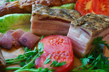 Salted traditional way of pieces of pork, along with chili and vegetables.